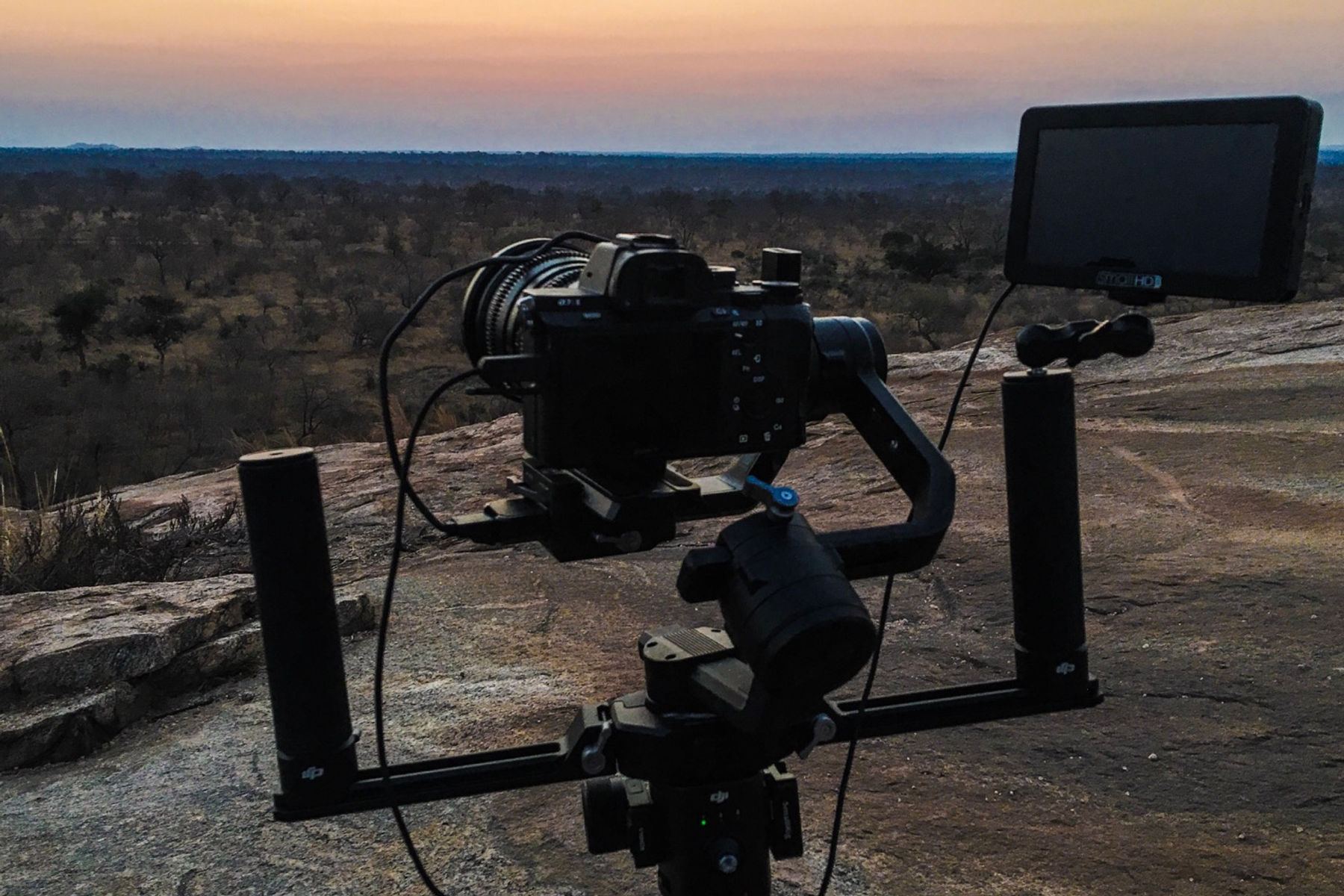 A camera on a gimbal rig at dusk
